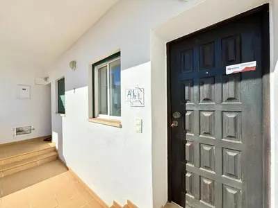 a black door in a hallway with a window at Albufeira Delight with Pool by Homing in Guia