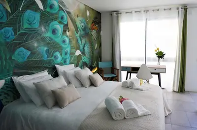 a bedroom with a large bed with towels on it at Le Jardin Secret de Faro Guesthouse in Faro