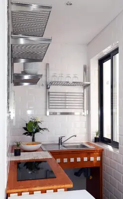 a kitchen with a sink and a counter top at Le Jardin Secret de Faro Guesthouse in Faro