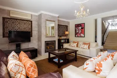 a living room with a couch and a tv at Casa Lago in Quinta do Lago