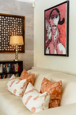 a living room with a white couch with pillows at Casa Lago in Quinta do Lago