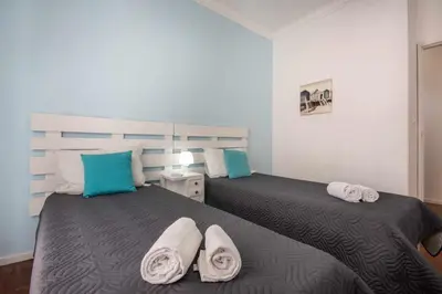 a bedroom with two beds with towels on them at T2 Apartamento do Tenis in Albufeira