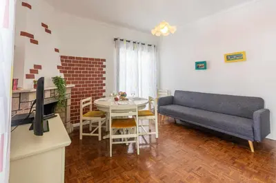 a living room with a couch and a table at T2 Apartamento do Tenis in Albufeira