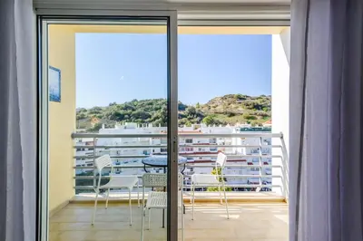 a room with a balcony with a table and chairs at Amazing apartment in Albufeira in Albufeira