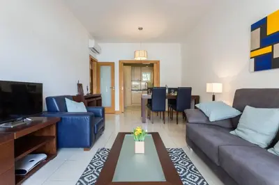 a living room with a couch and a table at Quinta Barracuda in Albufeira
