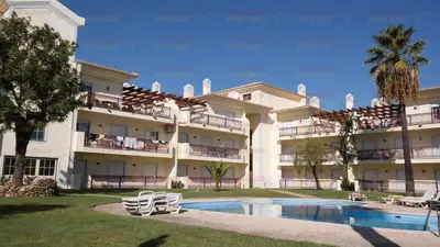 a large building with a swimming pool in front of it at Casablanca By Albufeira Rental in Albufeira