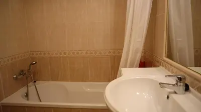 a bathroom with a sink and a tub and a toilet at Casablanca By Albufeira Rental in Albufeira