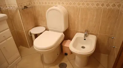 a bathroom with a toilet and a sink at Casablanca By Albufeira Rental in Albufeira