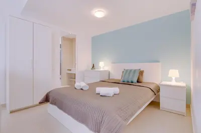 a bedroom with a bed with two towels on it at Cruzeiro do Sul Apartments - Vilamoura center in Vilamoura