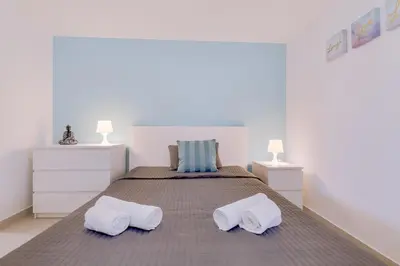 a bedroom with a large bed with two pillows at Cruzeiro do Sul Apartments - Vilamoura center in Vilamoura