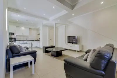 a living room with two couches and a television at Faro Tradicional House - City center in Faro