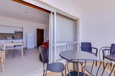 a kitchen and dining room with a table and chairs at York - Sea view - Quarteira in Quarteira
