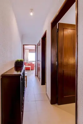 a hallway leading to a living room with a door at York - Sea view - Quarteira in Quarteira