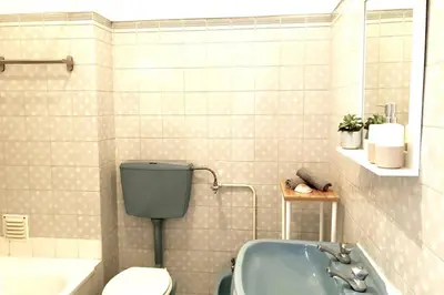 a bathroom with a toilet and a tub and a sink at OLDTOWN great Terrasse & ROOFTOP in Albufeira