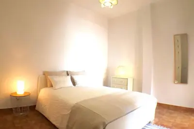 a bedroom with a large white bed and a window at OLDTOWN great Terrasse & ROOFTOP in Albufeira