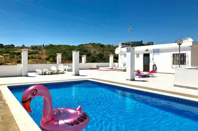 a pink plastic swan in a swimming pool at OLDTOWN great Terrasse & ROOFTOP in Albufeira