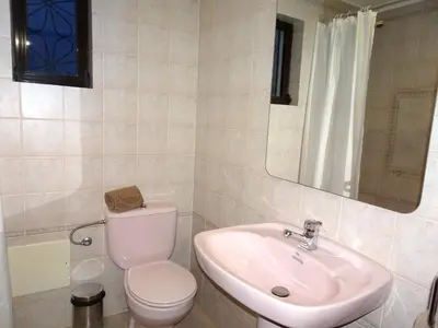 a bathroom with a sink and a toilet and a mirror at El Gharbe by Check-in Portugal in Albufeira