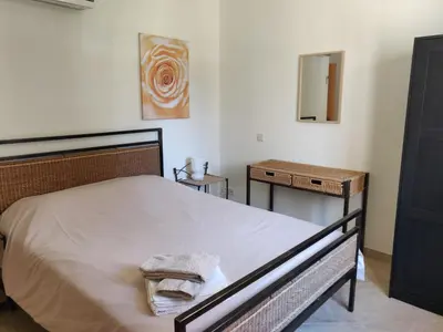 a bedroom with a bed with a mirror and a table at Algarve Albufeira, quiet apart with pool at 10 mn walk from Praia da Falesia in Olhos de Água