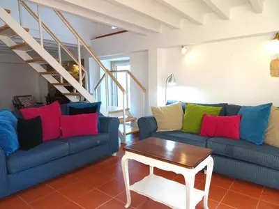 a living room with two blue couches and a table at Gold by Check-in Portugal in Albufeira