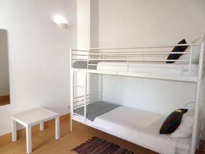 a room with two bunk beds and a table at Gold by Check-in Portugal in Albufeira