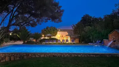a swimming pool in a yard at night at Gold by Check-in Portugal in Albufeira