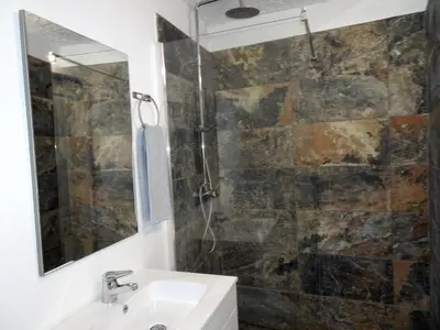 a bathroom with a sink and a shower with a mirror at Gold by Check-in Portugal in Albufeira