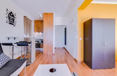 a living room with a couch and a kitchen at Sky - wonderful view to the beach - Quarteira in Quarteira