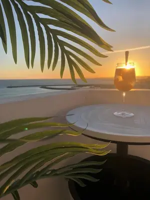 a candle sitting on top of a table on the beach at Sky - wonderful view to the beach - Quarteira in Quarteira