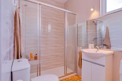a bathroom with a shower and a toilet and a sink at Sky - wonderful view to the beach - Quarteira in Quarteira