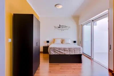 a bedroom with a bed and a large window at Sky - wonderful view to the beach - Quarteira in Quarteira