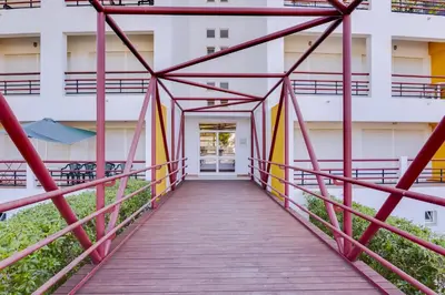 a wooden walkway leading to a building at Village Atlântico Apartment in Vilamoura
