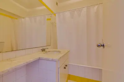 a bathroom with a sink and a shower at Village Atlântico Apartment in Vilamoura