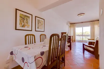 a dining room with a table and chairs at Village Atlântico Apartment in Vilamoura