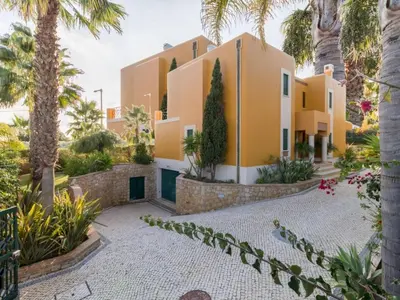 a house with palm trees in front of it at Casa Campo Spacious Living Private Pool Tranquil Setting in Guia