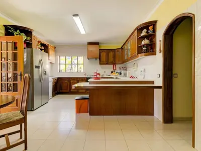 a kitchen with wooden cabinets and a stainless steel refrigerator at Casa Vilamoura in Vilamoura
