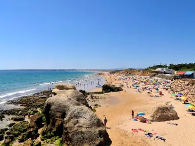 a group of people on a beach with the ocean at Beautiful Loule Villa Villa Quinta Tropical Private Pool Air Conditioning in Loulé