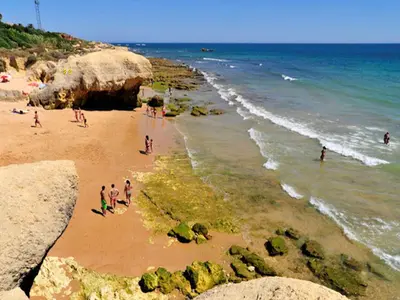 a group of people on a beach near the ocean at Beautiful Loule Villa Villa Quinta Tropical Private Pool Air Conditioning in Loulé