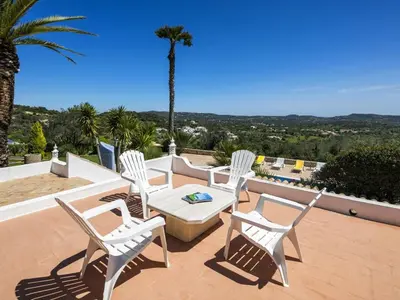 a group of chairs and a table on a patio at Beautiful Loule Villa Villa Quinta Tropical Private Pool Air Conditioning in Loulé