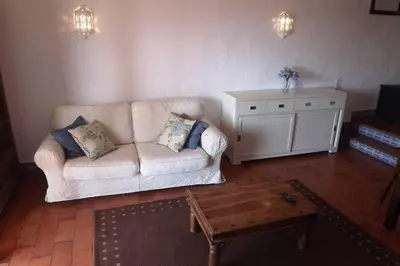 a living room with a couch and a coffee table at Casa Nill - Apartamento na Praia do Forte de São João em Albufeira in Albufeira