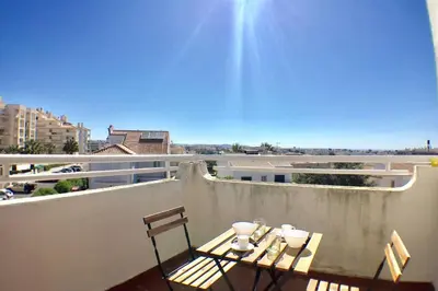 a table and chairs sitting on top of a balcony at Bellavista Avenida Pool and city center in Albufeira