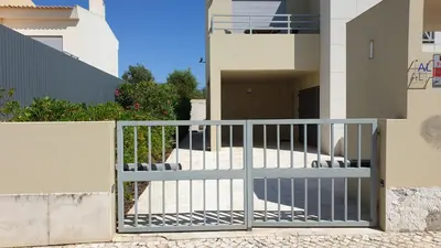 a gate in front of a house at Luxury Villa Corcovada Nicole with privat heated pool in Albufeira