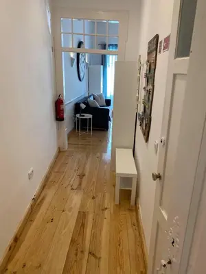 a hallway with a wooden floor in a living room at Faro Downtown Ria Formosa Studios in Faro