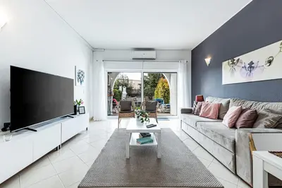 a living room with a couch and a flat screen tv at Edif. Valemangude in Albufeira