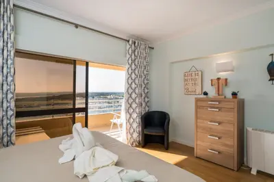 a bedroom with a bed and a window with a view at Marina Mar 'Penthouse' by SAPvillas in Vilamoura