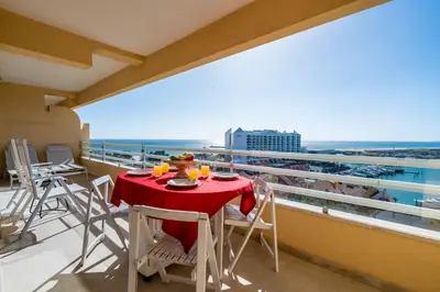 a balcony with a table and chairs and the ocean at Marina Mar 'Penthouse' by SAPvillas in Vilamoura