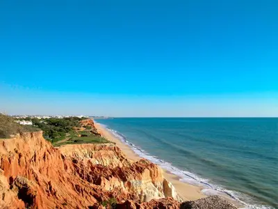 a view of a beach with rocks and the ocean at Holiday Home Vila Sol by Interhome in Cabeço de Câmara