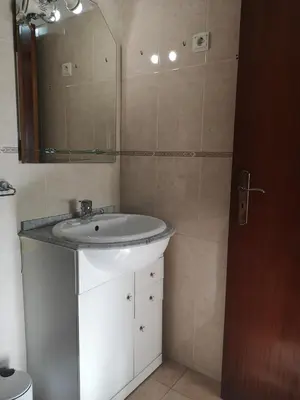 a bathroom with a sink and a mirror at Villa Vacations House in Albufeira