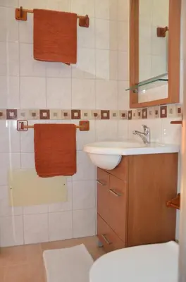 a bathroom with a sink and a mirror at Villa Vacations House in Albufeira