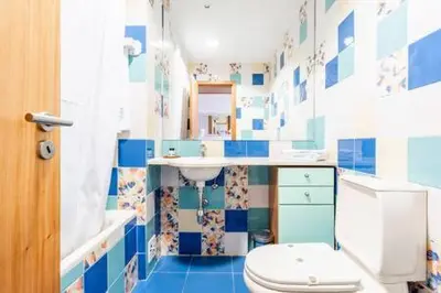 a blue and white bathroom with a toilet and a sink at Colorful Cozy Apartment view in Albufeira