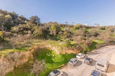 a group of cars parked on a dirt road at Albufeira Old Town Two bedroom Apartment Center in Albufeira
